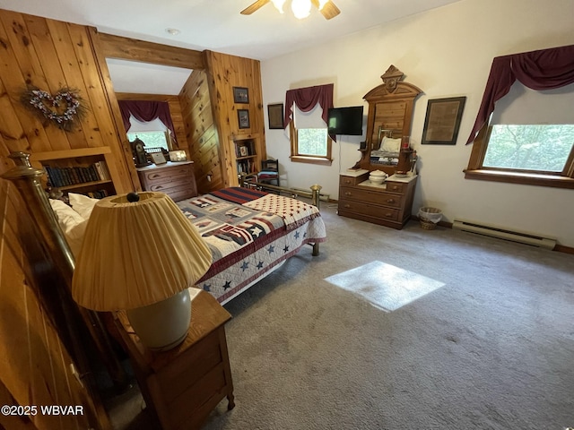 bedroom featuring a baseboard heating unit, wooden walls, and carpet floors