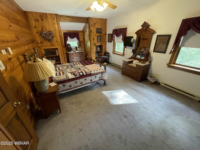 bedroom featuring carpet flooring, wooden walls, and baseboard heating