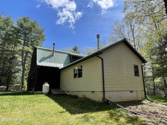 view of home's exterior featuring a lawn and crawl space