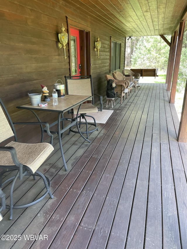 wooden deck featuring outdoor dining space