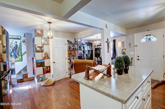 339 Spruce St, Jersey Shore, PA 17740 - kitchen featuring a chandelier, light wood-style flooring, white cabinetry, and hanging light fixtures