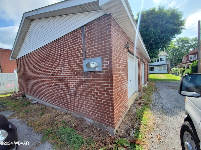 view of side of home featuring an outbuilding and a garage