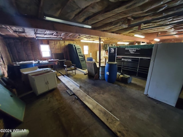 basement with white fridge