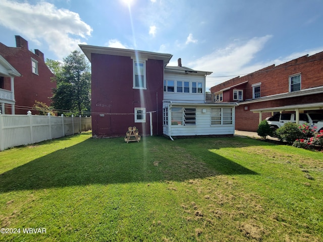 back of house with a yard