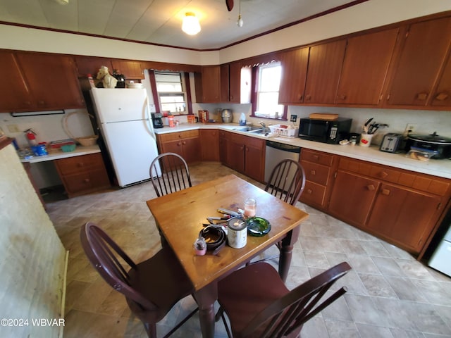 kitchen featuring sink, stainless steel dishwasher, and white refrigerator