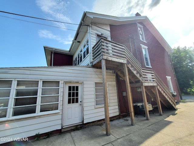 rear view of property featuring a balcony