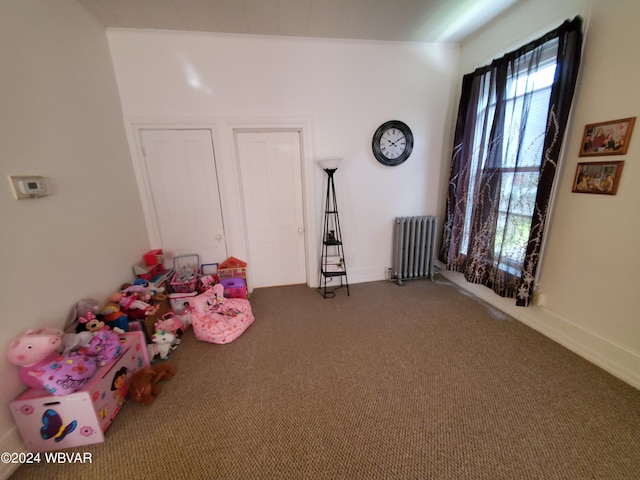 playroom featuring radiator heating unit and carpet floors