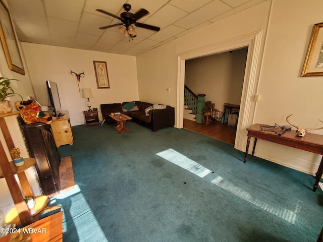 living room with ceiling fan and dark carpet