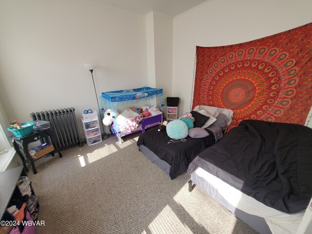 carpeted bedroom featuring radiator heating unit