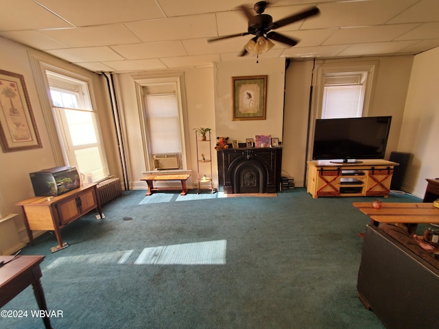 sitting room with carpet flooring, ceiling fan, and a paneled ceiling