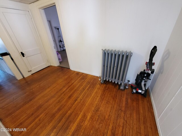 interior space featuring dark wood-type flooring and radiator