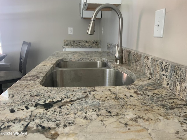 details with light stone countertops and sink