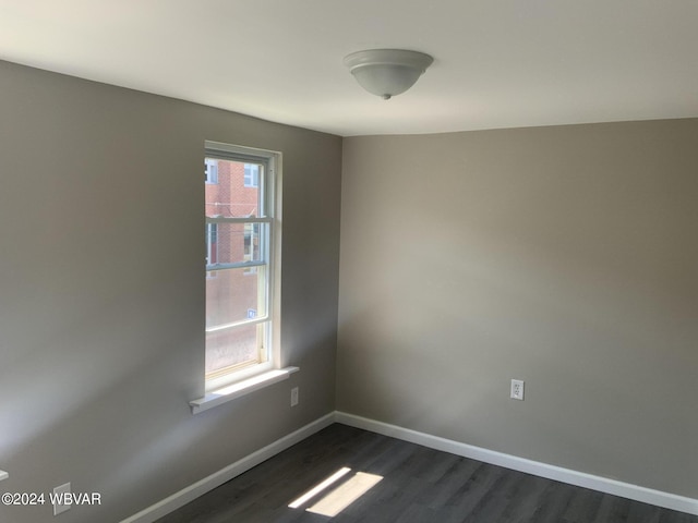 empty room with dark wood-type flooring