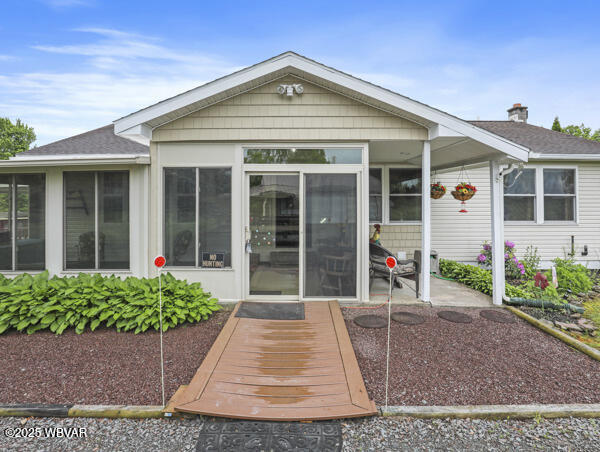 1498 Gainer Hill Rd, Dushore, PA 18614 - rear view of property featuring a sunroom and a shingled roof