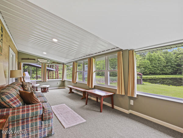 1498 Gainer Hill Rd, Dushore, PA 18614 - sunroom / solarium with healthy amount of natural light, lofted ceiling, carpet, and recessed lighting