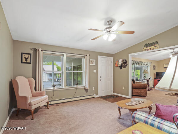 1498 Gainer Hill Rd, Dushore, PA 18614 - carpeted living area featuring a baseboard radiator and a ceiling fan