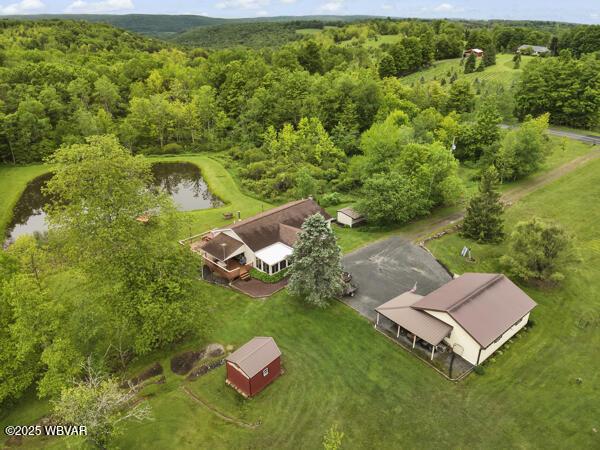 1498 Gainer Hill Rd, Dushore, PA 18614 - drone / aerial view of a large body of water and a heavily wooded area