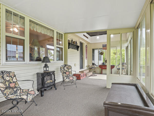 1498 Gainer Hill Rd, Dushore, PA 18614 - sunroom featuring a wood stove and carpet