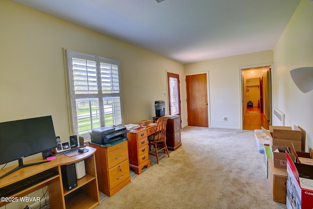 office space featuring visible vents, baseboards, and light carpet