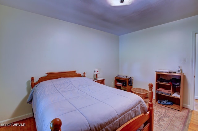 bedroom featuring baseboards and light wood-style flooring
