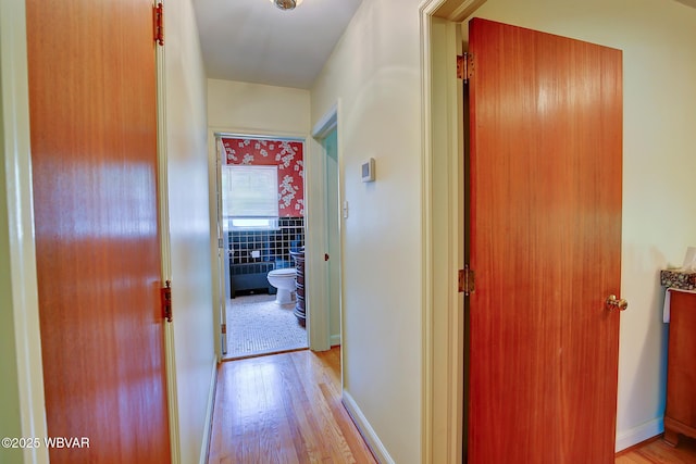 corridor featuring light wood finished floors