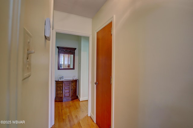 hallway with baseboards and light wood-type flooring