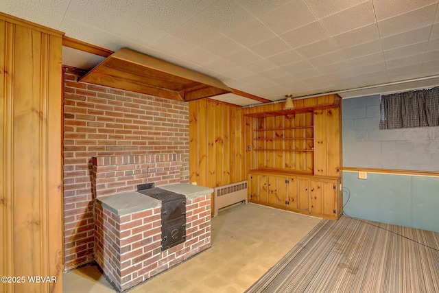 interior space featuring wood walls and radiator heating unit