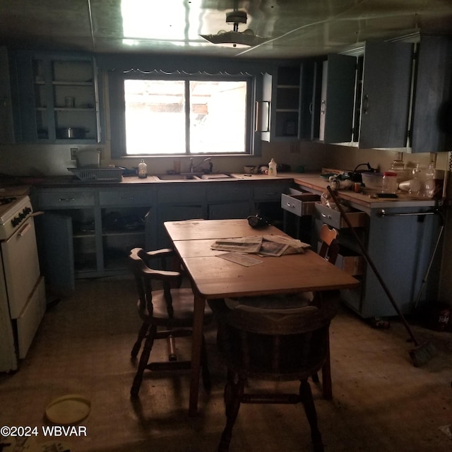 kitchen with white gas stove and sink