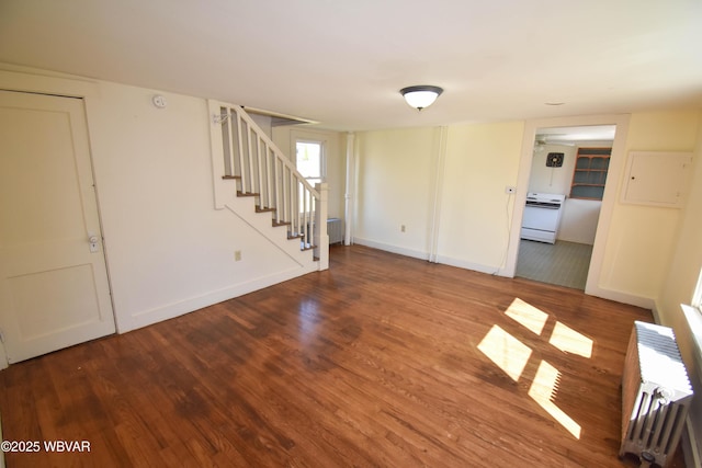 interior space with wood-type flooring and radiator heating unit