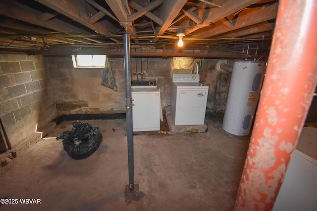 basement featuring washer and dryer and electric water heater