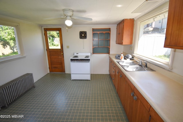 kitchen with ceiling fan, sink, radiator heating unit, and white electric range