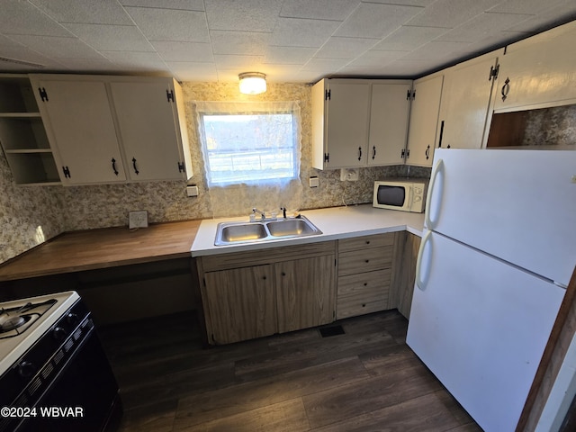 kitchen featuring decorative backsplash, white appliances, sink, and dark wood-type flooring