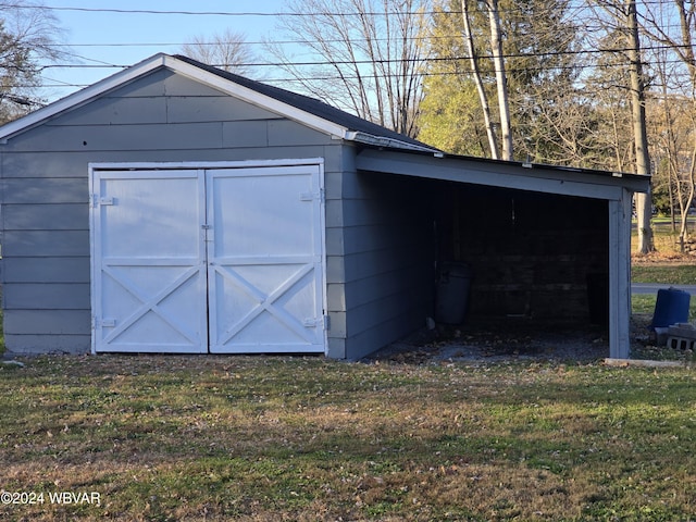 view of outbuilding featuring a yard