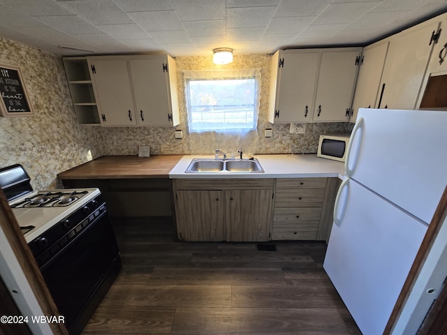 kitchen featuring dark hardwood / wood-style flooring, sink, and white appliances