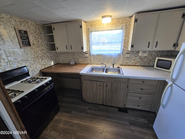 kitchen featuring white cabinets, dark hardwood / wood-style flooring, white appliances, and sink