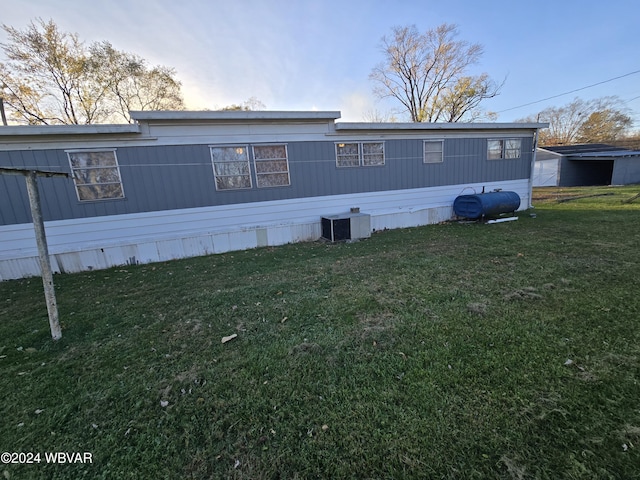 exterior space featuring a yard and central AC unit