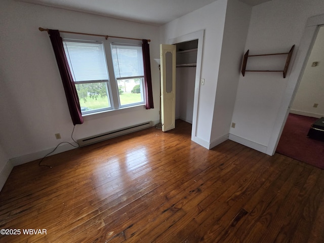 unfurnished bedroom with a baseboard radiator, dark hardwood / wood-style floors, and a closet