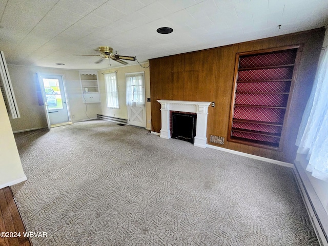 unfurnished living room with a wealth of natural light, built in features, and carpet