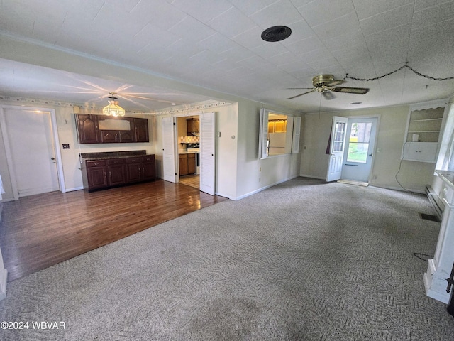 unfurnished living room with hardwood / wood-style floors and ceiling fan