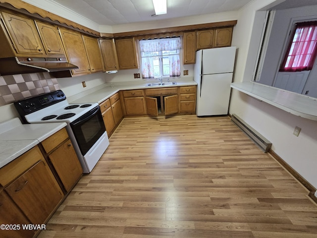 kitchen featuring light hardwood / wood-style flooring, baseboard heating, range with electric cooktop, a healthy amount of sunlight, and white fridge