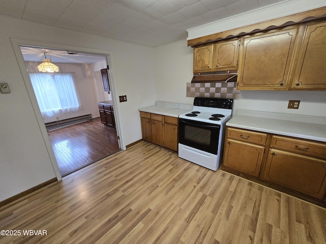 kitchen with electric stove, a baseboard radiator, decorative light fixtures, and light hardwood / wood-style flooring