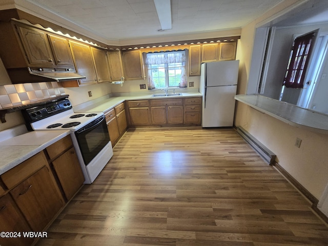 kitchen featuring sink, range with electric stovetop, stainless steel refrigerator, a baseboard radiator, and light hardwood / wood-style floors