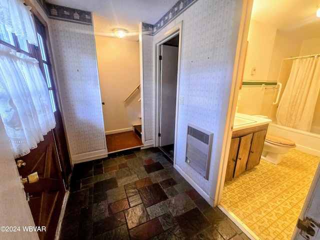 full bathroom featuring shower / tub combo with curtain, vanity, toilet, and heating unit