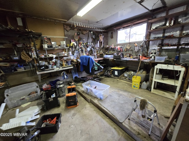 miscellaneous room with a workshop area and concrete floors