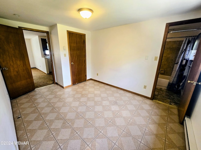 unfurnished bedroom featuring a closet and a baseboard heating unit