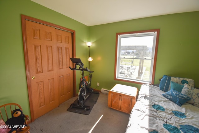 bedroom with carpet, a baseboard radiator, and a closet