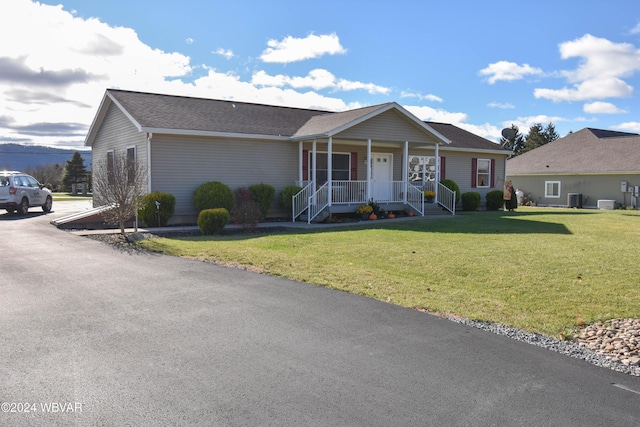 ranch-style house with covered porch and a front yard