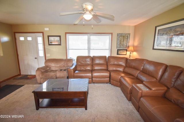 carpeted living room with ceiling fan