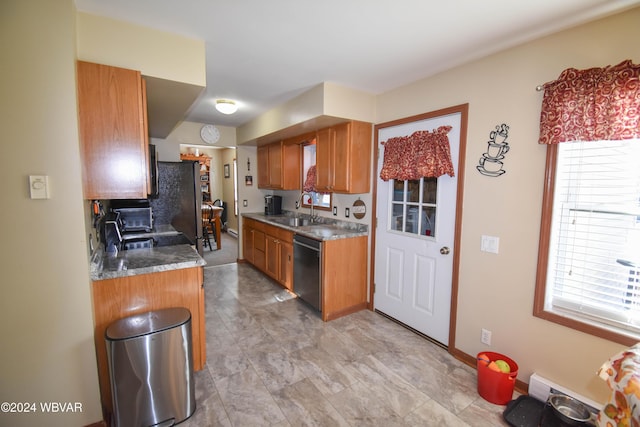 kitchen with refrigerator, a healthy amount of sunlight, sink, and black dishwasher