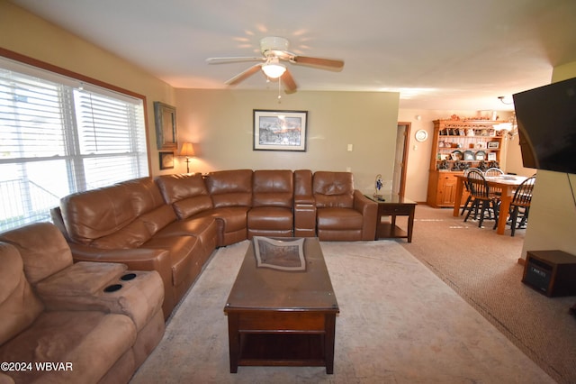 carpeted living room featuring ceiling fan